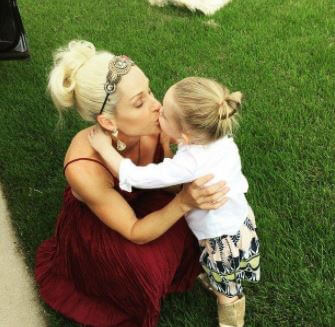 Michelle is kissing her daughter Kaia on an Instagram post